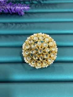 Adjustable Pachi Kundan finger ring. Gold plated hand made. Bead detailing all around. Flower design Round shape about 1 and half inch in diameter. Perfect to finish any traditional look. Kundan Ring, Traditional Look, Finger Ring, Ring Finger, Ring Gold, Flower Design, Round Shape, Flower Designs, Hand Made