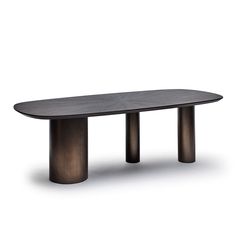 an oval dining table with two metal legs and a black finish on the top, in front of a white background