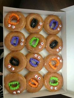 a box filled with donuts decorated like monsters