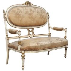 an antique style chair is upholstered with gold leaf trimmings and ornate detailing