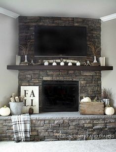 the fireplace is decorated with white pumpkins and other fall decorations, including an old fashioned television