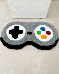 a game controller shaped rug on the floor