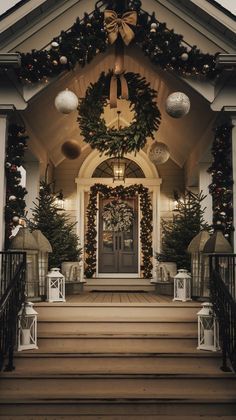 the front entrance of a house decorated for christmas with wreaths and lights on it