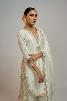 Editor's Note Elevate your style with a fusion of contemporary design and traditional elegance. This kurta, dupatta, and pant set is meticulously crafted with intricate detailing, a flattering pattern, and a perfect blend of modern and ethnic elements. It's a statement ensemble that effortlessly combines grace and modern flair. Hand Embroidery On Neck, Gota Embroidery, White Pant, Boutique Suits, White Kurta, Sharara Set, Boutique Fashion, Suit Designs, Punjabi Suits