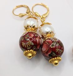 "Multiple Variations of Japanese Tensha Bead Dangle earrings, some with 10mm freshwater pearls and 12mm or 10mm or 12x15mm flower beads. All have gold-plated lever back ear wires/bead caps/wire wraps. The shortest dangle length is ~1.75 inches to the longest ~2.0 inches. The dark red barrel bead is topped off with tiny Czech bell flowers I wire wrapped and attached to chain. Tensha beads are made and imported solely from Japan. Their history goes back many years. A beautiful design is \"transfer Elegant Adjustable Multicolor Flower Earrings, Elegant Adjustable Flower Earrings With Dangling Beads, Elegant Multicolor Round Beads Flower Earrings, Elegant Adjustable Flower Shaped Beaded Earrings, Elegant Adjustable Flower Earrings With Round Beads, Tensha Beads, Bell Flowers, Bead Dangle Earrings, Silver Gift Box