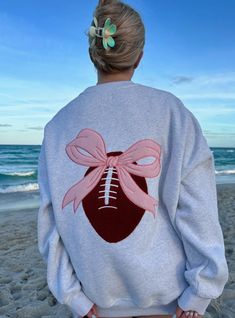 Discover the ultimate game day sweatshirt - the Game Day Coquette Bow Football Embroider Sweatshirt. Pink Embroidered College Sweatshirt, Embroidered Long Sleeve College Sweater, Embroidered Long Sleeve Sweater For College, Embroidered Long Sleeve Tops For College, Varsity Long Sleeve Top With Letter Embroidery, Pink Long Sleeve Sweatshirt With Machine Embroidery, Sporty Crew Neck Sweatshirt With Machine Embroidery, Pink Long Sleeve Sweatshirt With Embroidery, Machine Embroidered Crew Neck Top For College