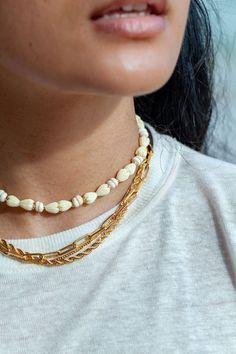 "Flanked with natural white puka shells and pikake flowers, this unique choker necklace evokes visions of Hawaii's white sands and soothing shores. Stack this gold necklace with other beaded beauties and you'll be ready for your tropical escape. ✦ DETAILS ✦ ✧ Name: Me'e (MAY aye) - Heroine. ✧ Adjustable from 14\"- 16\". ✧ 6-7mm White Puka Shells. ✧ Carved Resin Pikake Flowers. ✧ 14kt Gold Filled with lobster clasp. ✧ All Ke Aloha Jewelry pieces come packaged thoughtfully, beautifully, and ready Unique Choker Necklaces, Hawaii Necklace, Unique Choker, Hawaii Jewelry, Puka Shell Necklace, Shell Choker, Tropical Escape, Stacked Necklaces, Puka Shell