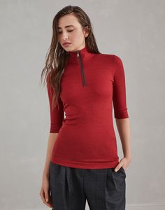 Ribbed wool jersey turtleneck t-shirt with precious half zip A sporty style and distinctly feminine details come together perfectly in this wool jersey mock neck T-shirt. The timeless, slightly three-dimensional ribbing follows the fitted lines of the silhouette, characterized by regular shoulders and elbow-length sleeves. The zipper closure highlights the garment’s casual nature and is enriched with a precious embroidery of fine rows of shiny monili for a delicate sparkle. High Neck Merino Wool Tops For Fall, Half-zip Ribbed Collar Top For Work, Winter Funnel Neck Top With Zipper Closure, Merino Wool Tops With Ribbed Collar, Red Crew Neck Top With Ribbed Cuffs, Luxury Red Top With Ribbed Collar, Fine Knit Merino Wool High Neck Top, Fine Knit High Neck Merino Wool Top, Stretch Merino Wool Turtleneck Top