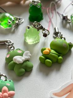 several green and white keychains are on a table with other toy items in the background