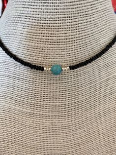 "This hand-made beaded choker necklace is perfect for any occasion. The necklace is made with mostly black beads. A statement turquoise stone sits in the middle, surrounded by silver beads.  3 sizes available: 14\" (most common for women), 16\" and 18\" (most common for men). These sizes are measured at the loosest point of the necklace but can be adjusted to be slightly tighter. Please check your size before ordering and message me if you have any questions or measurement requests. Disclaimer: Beaded Necklace Black, Turquoise Choker, Turquoise Bead Necklaces, Beaded Choker Necklace, Necklace Black, Beaded Choker, Turquoise Beads, Black Beads, Turquoise Stone