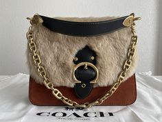 COACH Beat Brown/Brass Shoulder Bag In Suede Leather and Shearling NWT. New with tags, original dust bag included. For additional details please let me know. Thank you for looking. Luxury Winter Shoulder Bag, Luxury Leather Shoulder Bag With Faux Fur Lining, Designer Leather Bags For Winter, Let Me Know, Suede Leather, Dust Bag, Let Me, Thank You, Brass