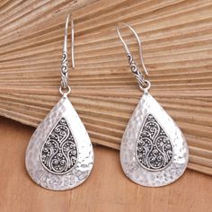 Artisan Ketut Udiana adds traditional Balinese motifs to a stunning sterling silver design. These exquisite dangle earrings feature hammered details surrounding the centerpieces. The hooks allow the accessory to dangle gracefully, making an alluring addition to your jewelry collection. Silver Hammered Bohemian Earrings, Bohemian Silver Hammered Earrings, Traditional Nickel-free Sterling Silver Teardrop Earrings, Bohemian Hammered Sterling Silver Earrings, Bohemian Sterling Silver Hammered Earrings, Traditional Silver Drop Earrings, Traditional Silver Teardrop Pierced Earrings, Traditional Silver Drop Jewelry, Elegant Hammered Sterling Silver Teardrop Earrings