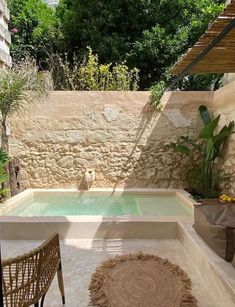 an outdoor hot tub in the middle of a patio