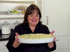 a woman holding a bowl full of food