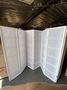 an open white room divider sitting inside of a building