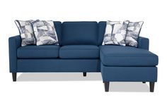 a blue sectional couch with pillows on it