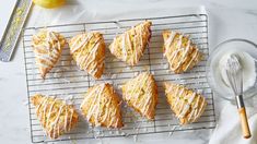 nine lemon scones on a cooling rack next to a whisk