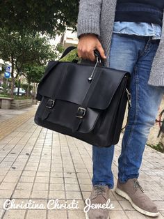 "Handmade leather briefcase made from 100% genuine leather in black color decorated with a unique key ring. In Christina Christi Jewels store you can see more than 15 designs in Leather Messenger Bags. You can have them in 2-4 Days with DHL EXPRESS SHIPPING YOU CAN BUY THIS BAG WITH OR WITHOUT DECORATION. - Accommodates a 17'' laptop. - 3 sections (2 main + 1 big front pocket) - Front pocket accommodates a 11\" inch laptop or tablet. - Zippered pocket on the backside. - Fully adjustable and deta Black Leather Laptop Bag For School, Black Satchel Briefcase For School, Classic Black Shoulder Bag As A Gift, Classic Black Shoulder Bag As Gift, Black Leather Satchel Briefcase, Black Rectangular Briefcase For Everyday Use, Black Office Bag With Leather Strap, Rectangular Black Leather Briefcase, Black Rectangular Briefcase For School