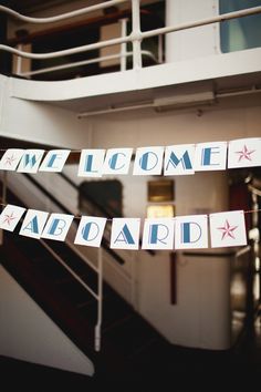 some signs hanging from the side of a stair case in front of a stairwell way