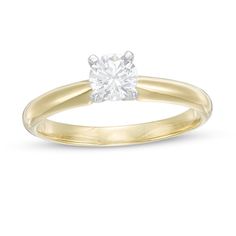 a yellow gold engagement ring with a single diamond