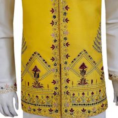 A handcrafted yellow designer waistcoat that elevates your look beyond compare. Crafted with meticulous attention to detail by skilled artisans, this waistcoat isn't just another import. It's a statement piece designed to turn heads at American mehndi celebrations. The vibrant yellow hue is a burst of festivity, while the premium quality fabric drapes effortlessly, ensuring a comfortable and sophisticated fit. Multicolor handwork adorns the waistcoat, each intricate detail a testament to the artistry behind this masterpiece. The exquisite craftsmanship is guaranteed to leave a lasting impression, making you the center of attention on your special day. Pair this stunning waistcoat with a classic white kurta pajama for a timeless mehndi ensemble that exudes sophistication. Customizable Perfe Fitted Yellow Traditional Wear For Transitional Season, Fitted Yellow Traditional Wear, Yellow Kurta With Intricate Embroidery For Festivals, Yellow Kurta With Intricate Embroidery For Transitional Season, Yellow Sherwani With Dabka Work For Designer Wear, Designer Yellow Sherwani With Dabka Work, Yellow Dabka Sherwani For Festivals, Yellow Sherwani With Dabka For Festivals, Traditional Yellow Embroidered Bandhgala