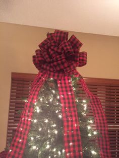 a christmas tree with a red and black bow