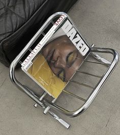 a magazine rack sitting on the ground next to a couch