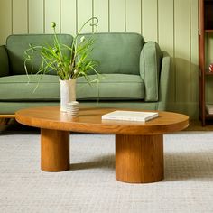 a living room with a green couch and coffee table