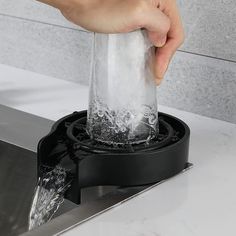 a person is washing their hands in a sink with water coming out of the faucet