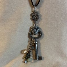 I Am Listing A Few Key Necklaces That Are Similar - This One Is Number 6. All Of Them Are Unique. This Is An Antique Key That Is On A Brown Suede Cord With A Cluster Of Beads. I Used Antiqued Silver Colored Charms And Links To Create This Necklace. Beads Are Crystal And Also Luster Finish Glass. This Is A New Item And Never Worn. The Key Pendant Portion Is 3 Inches Long And The Cord Is About 25 Inches Long Antique Key Necklace, Key Necklaces, Key Jewelry, Antique Keys, Necklace Beads, Number 6, Suede Cord, Key Necklace, Key Pendant