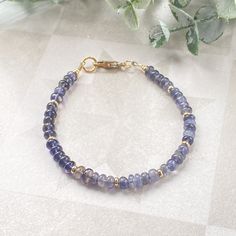 This juicy gemstone beaded bracelet is full of color!  The bracelet band is made of the most beautiful purpley- blue 4mm iolite rondelle beads.  Every fifth rondelle bead is accented with a 14k gold filled heishi bead.  A simple 14k gold filled minimalist lobster claw finishes off this bracelet.  This sweet, delicate bracelet is bursting with color and would look amazing alone on your wrist or paired with friends for your own unique stack.  It can also make a very thoughtful gift for friends and Everyday Purple Hand-strung Jewelry, Handmade 14k Gold-filled Bohemian Bracelet, Handmade Bohemian 14k Gold-filled Bracelet, Handmade 14k Gold Filled Bohemian Bracelet, 14k Gold Filled Spiritual Bracelets For Everyday, 14k Gold Filled Spiritual Bracelet For Everyday, Dainty Blue Gemstone Beaded Bracelets, Blue Dainty Gemstone Beaded Bracelet, Spiritual 14k Gold Filled Bracelet For Everyday