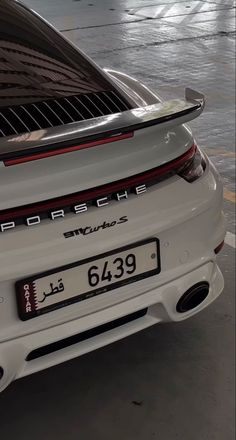 the rear end of a white porsche sports car