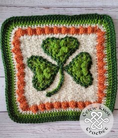 a crocheted pot holder with shamrocks on it