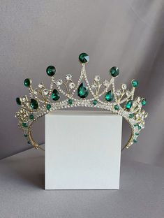 "You have a great opportunity You can buy earrings complete with this crown for only $ 7 Beautiful sparkling tiara with emerald stones in gold plated. This wonderful tiara is for true queens. This crown is suitable for any event. Such as a ball, a wedding, a photo session, themed parties, etc. It will look great on the bride. I'm sure you will get a lot of compliments. A spectacular tiara fit for an extremely elegant woman on her wedding day!  All my handmade jewelry with the best materials for Emerald Crown, Emerald Tiara, Tiara Royal, Quinceanera Jewelry, Quinceanera Crown, Tiara Headpieces, Headpiece Diy, Silver Tiara, Beautiful Tiaras