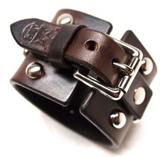 "This brown leather cuff is made using American bridle leather. The finest, most sumptuous leather tanned in North America. I hand work the edges slick and stud the top accordingly. I've been making this cuff for years and love making it! Made for your wrist size. Instructions in the pics above! - 2\" wide - premium bridle leather Thanks! Freddie" Leather Bracelet With Palladium Hardware As Gift, Distressed Brown Leather Cuff Bracelet, Classic Brown Leather Bracelet, Classic Brown Leather Bracelet With Wrist Strap, Brown Leather Bracelet With Palladium Hardware, Classic Handmade Leather Cuff Bracelet, Leather Cuff Bracelets With Custom Hardware, Vintage Leather Wristband With Leather Strap, Adjustable Brown Leather Bracelet With Custom Hardware