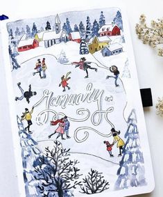 a notebook with an illustration of people skiing in the snow