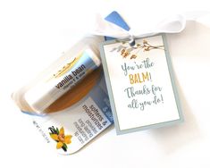 a bottle of balm next to a tag with the message you're the balm