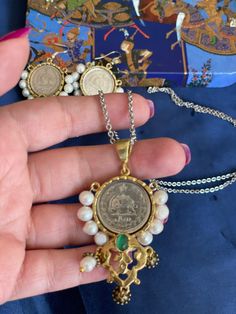 Beautiful ancient Pahlavi coins Necklace . with pearl and a beautiful green stone in the middle  Chain is Steal  Made In USA  Thank you  for visiting my shop . If you  have any questions don't hesitate to ask .  I can send you more pictures and videos if you like . ❌NOTE : ❌ please understand that all items are handmade and may have minor imperfections by nature . Thank you  Suzan Green Necklace With Coin Pendant As Gift, Green Necklace With Coin Pendant For Gift, Festival Coin Pendant Jewelry As Gift, Festival Coin Pendant Jewelry Gift, Festival Gift Jewelry With Coin Pendant, Traditional Coin Shaped Jewelry For Gifts, Traditional Coin Shaped Jewelry Gift, Pearl Chain Coin Necklace, Pearl Chain Coin Necklace As Gift