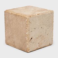 a block of cement sitting on top of a white surface