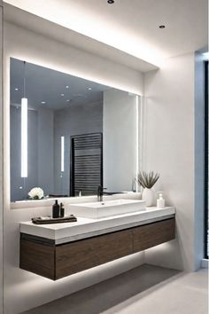 a bathroom with a large mirror above the sink