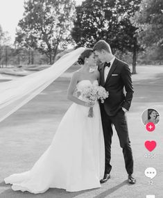 the bride and groom are posing for their wedding photo in black and white with red hearts