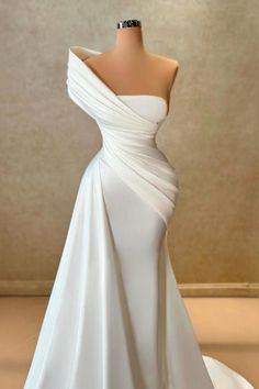 This stunning wedding dress features a sleek one shoulder design with a mermaid silhouette, crafted from luxurious satin material. The sleeveless style adds a touch of femininity, perfect for any bride looking for a simple yet elegant look on her special day. Feel confident and beautiful in this timeless piece. Asymmetrical Neckline Satin Evening Dress For Wedding, Elegant One Shoulder Wedding Dress With Sweep Train, Elegant One Shoulder Dress With Sweep Train For Wedding, Asymmetrical Neckline Satin Wedding Gown, Wedding Evening Dress With Sweep Train And Asymmetrical Neckline, Wedding Evening Dress With Asymmetrical Neckline And Sweep Train, White Mermaid Gown With Sweep Train, White Fitted Gown With Asymmetrical Neckline, Elegant One-shoulder Dress For Wedding And Prom Season