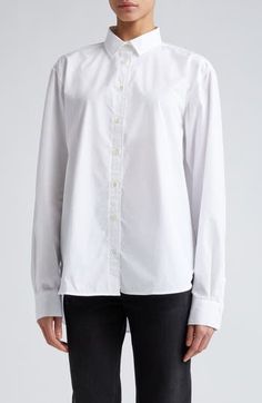 A slightly oversized fit and a high/low shirttail hem distinguish this classic button-up shirt cut from crisp organic cotton poplin. 27 1/2" front length; 30" back length (size 2US/34EU)   Front button closure   Point collar   Long sleeves with button cuffs   Curved hem   100% organic cotton   Dry clean or machine wash, dry flat   Made in Portugal   SPACE: A shop for emerging and advanced designers Classic Poplin Tops For Fall, Classic Poplin Tops With Button Cuffs, Poplin Shirt With Button Closure For Daywear, Daywear Poplin Tops With Button Closure, Classic Poplin Tops With Button Closure, Daywear Tops With Button Closure, Poplin Tops With Button Closure For Daywear, Classic Shirt With Concealed Placket And Shirttail Hem, Classic Blouse With Relaxed Fit And Shirttail Hem