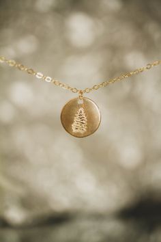 This cute layering necklace is perfect to wear all by itself, or to pair it with other necklaces. The cute pine tree design can be a simple cute tree for the holiday season or a symbol of a tree that stands through all weather and all seasons.  The necklace is customizable for length & made with 14k gold filled jewelry or sterling silver. If taken care of, the necklace will last a super long time! Both lead and nickel free! For more information on our jewelry & how to take care of 14k gold fille Dainty 14k Gold Filled Hand Stamped Necklace, Dainty Personalized Necklaces For Christmas, Minimalist Jewelry For Christmas Gifts, Dainty Personalized Christmas Necklaces, Minimalist Jewelry As Christmas Gift, Minimalist Christmas Jewelry Gift, Dainty Gold Jewelry For Christmas, Dainty Personalized Christmas Jewelry, Pine Tree Design