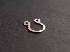 14k gold filled / 14k rose gold filled / sterling silver wire faux septum ring. Small and delicate piece with a hammered finish that gives a beautiful shine. This listing is for ONE septum ring only. g o l d . f i l l Gold-fill is an actual layer of gold bonded with pressure to another metal, usually brass or copper. Gold-fill is not to be confused with gold plating as gold-fill has a much thicker layer of gold. Gold filled jewelry does not flake off or rub off and with proper care it can last a Elegant Gold Septum Ring Nickel Free, Elegant Nickel-free Gold Septum Ring, Elegant Gold Nickel-free Septum Ring, Silver Septum Piercing, Fake Septum Ring, Nose Ring Gold, Faux Septum Ring, Faux Nose Ring, Fake Nose Ring