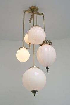 three light fixtures hanging from the ceiling in a room