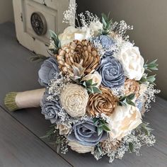 a bridal bouquet on a table with flowers