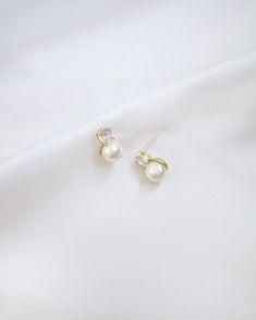 A delicate pair of pearl stud earring accented with sparkling rhinestones creates an elegant and versatile style, suitable for both formal occasions and everyday wear. Perfect for date night, wedding, bridesmaids, holiday party, and any special occasions. DETAILS: MEASUREMENT: 0.5" LENGTHCOLOR: GOLDIMPORTED MATERIALS Dainty Akoya Pearl Earrings For Formal Occasions, Dainty White Akoya Pearl Earrings, 14k Gold-filled Pearl Earrings For Wedding, Elegant 14k Gold-filled Pearl Earrings For Formal Occasions, White 14k Gold-filled Pearl Earrings For Wedding, Night Wedding, Pearl Stud Earrings, Pearl Studs, Stud Earring