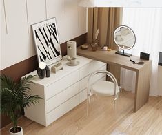 a room with a desk, mirror and plant in the corner next to it on top of a hard wood floor