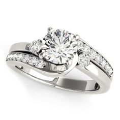 a white gold ring with two diamonds on the band and a center stone in the middle